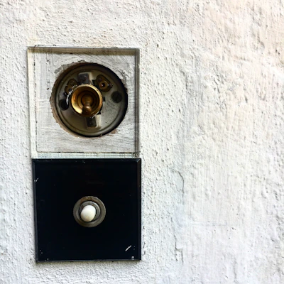 Close-up of hands installing a modern light switch in a cozy living room.