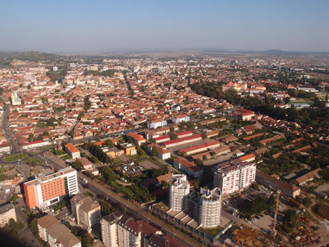 Aerial view of bustling Coimbatore city with mixed-use developments and busy marketplaces.