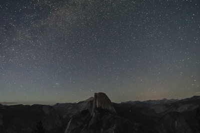 Starry night sky over the Roque Nublo rock formation on Gran Canaria island.