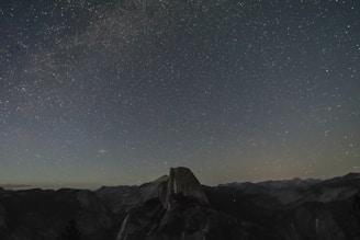 Starry night sky over the Roque Nublo rock formation on Gran Canaria island.