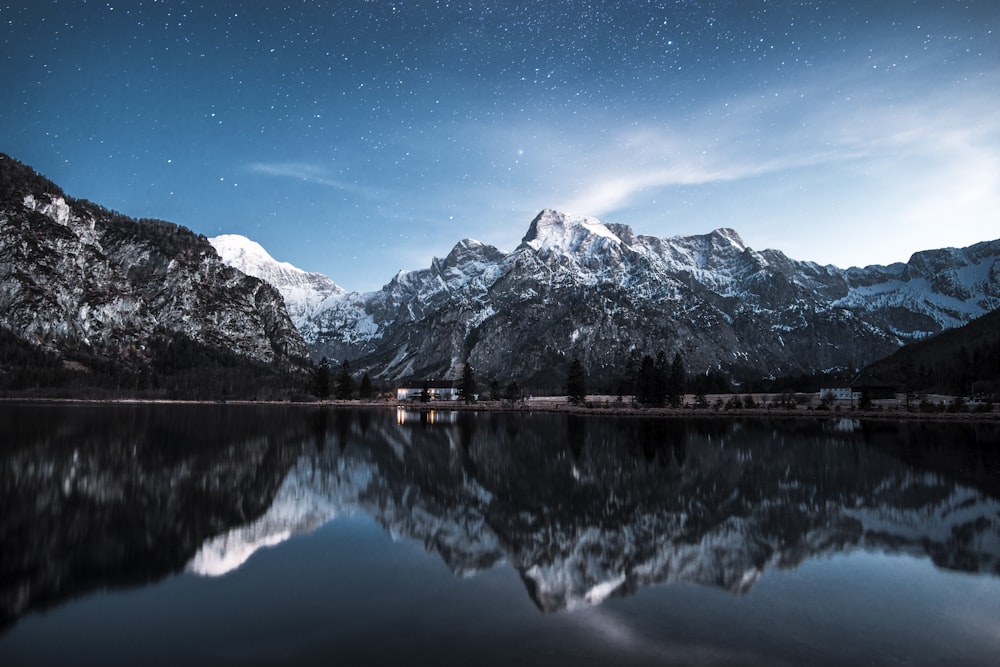 body of water surrounded with mountain