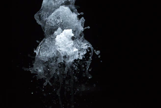 A dynamic splash of paint captured mid-air against a dark background.