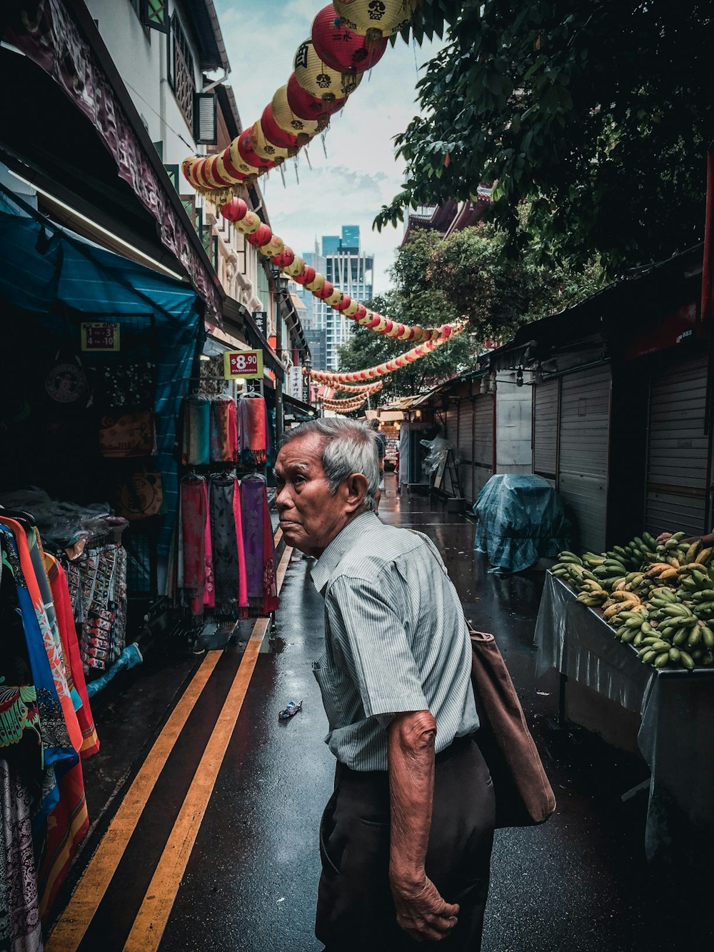 man walking on alley with stores