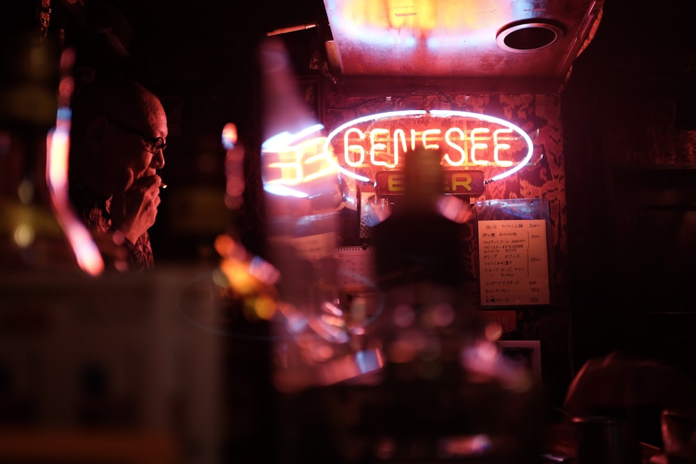 tilt shift photography of red and blue Genesee neon signage