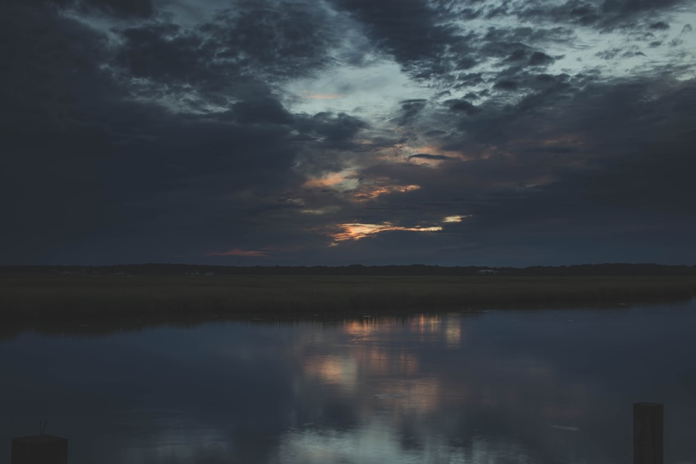 calm body of water under gray skies