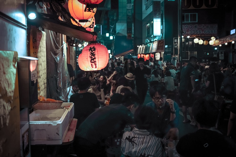 photo of people gathering in market during nighttime