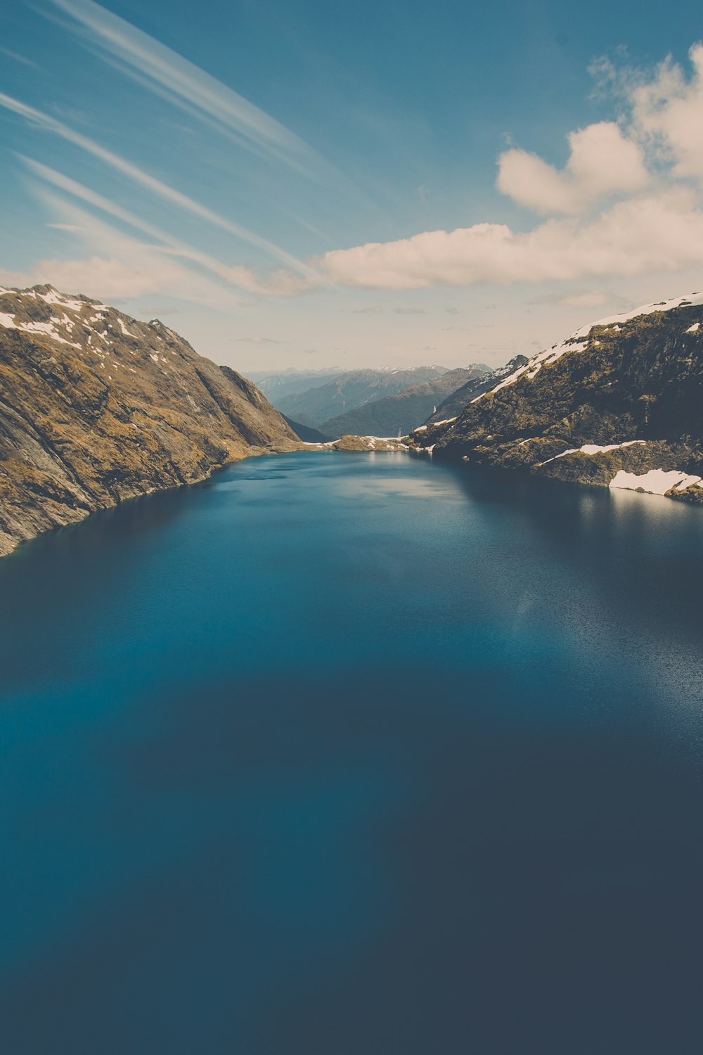 river between mountains under clear sky