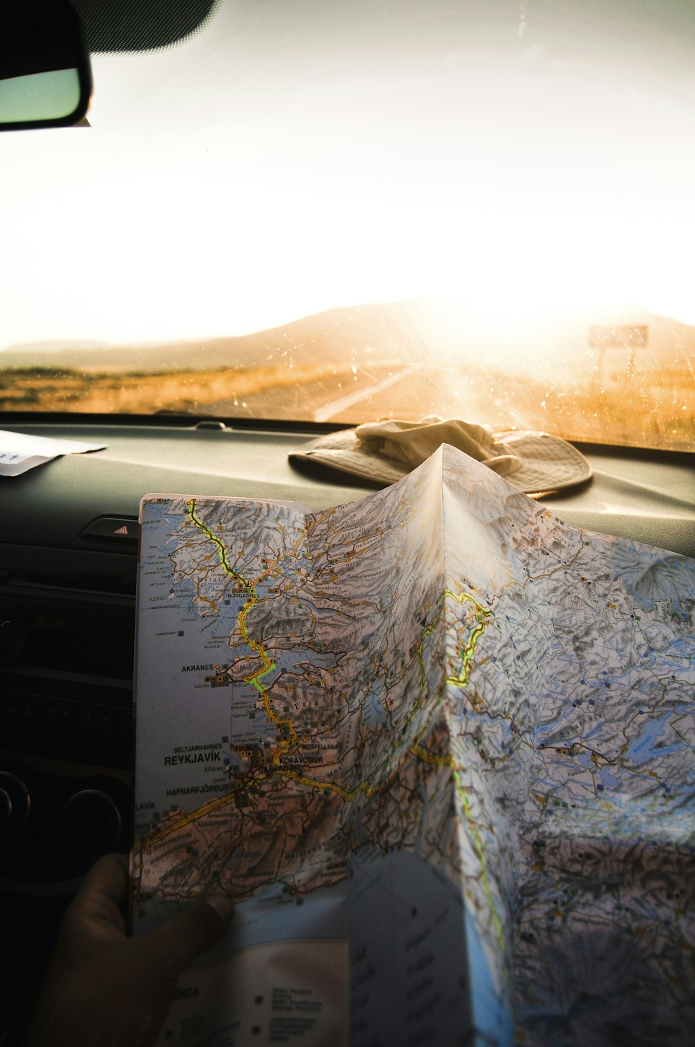 person holding blue and brown map