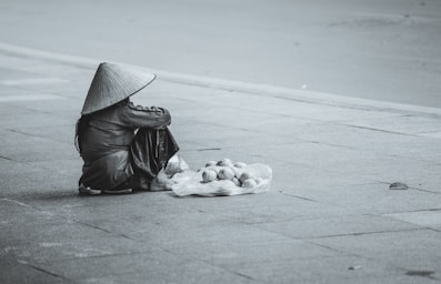 negative space for photo composition,how to photograph asian rain hat; person sitting beside street