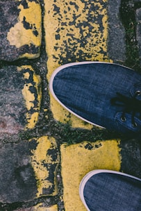 A pair of stylish, durable sneakers resting on a cobblestone street, hinting at movement and comfort.