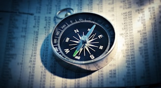 shallow focus photograph of black and gray compass