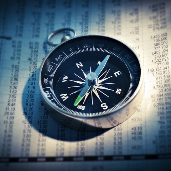 shallow focus photograph of black and gray compass