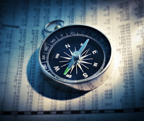 shallow focus photograph of black and gray compass