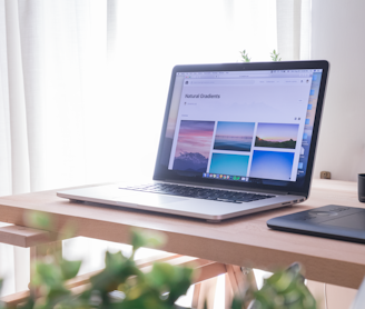 opened gray and black laptop on wooden desk