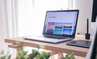 opened gray and black laptop on wooden desk