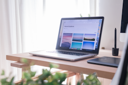 opened gray and black laptop on wooden desk
