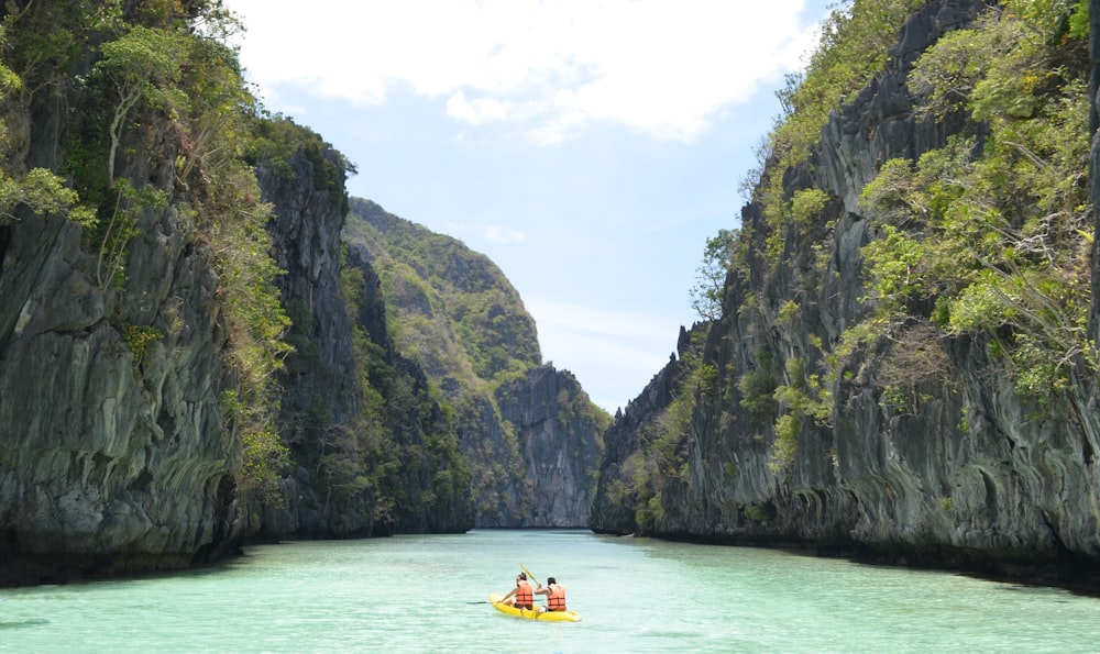 two men wearing life vest on boat