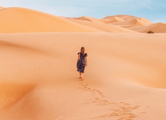 woman walking at desert