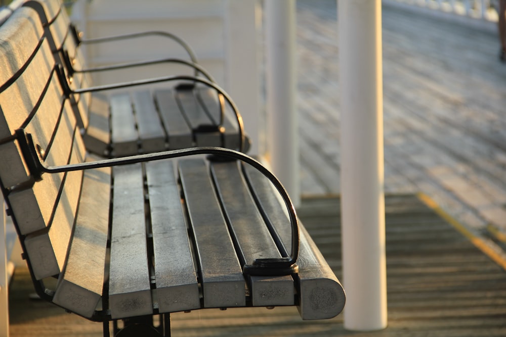 shallow focus photography of grey wooden benches
