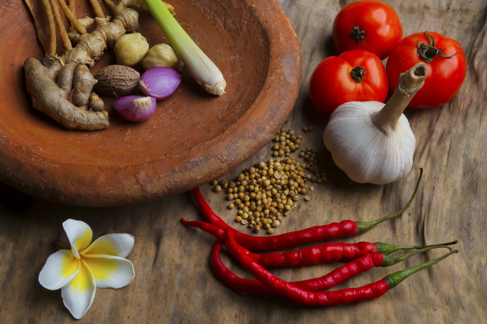 round brown clay bowl with vegetables