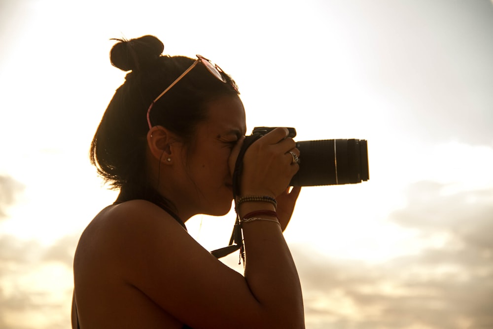 woman holding DSLR camera