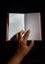 Close-up of hands flipping through a colorful mindfulness activity book.