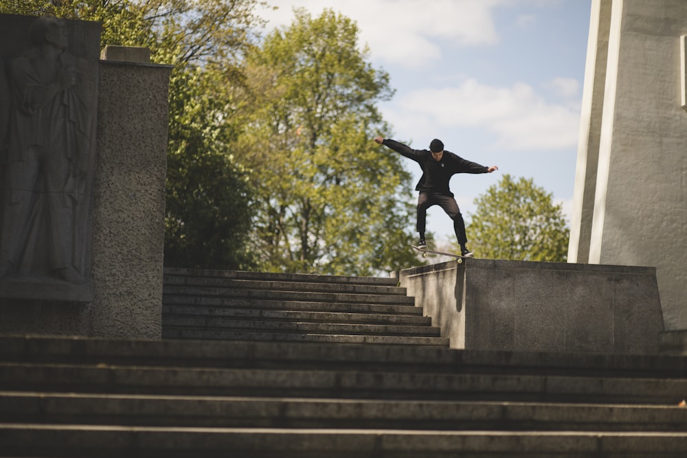 man riding on skateboard while doing nose grind trick