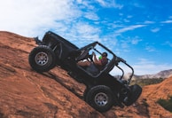 man riding a black off-road vehicle