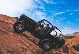 man riding a black off-road vehicle
