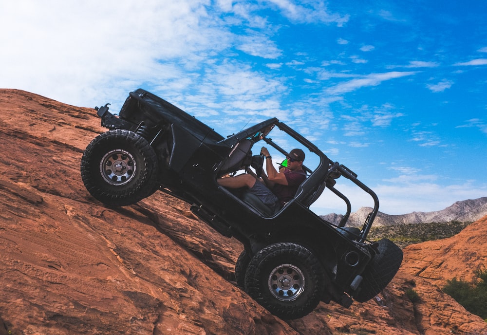 man riding a black off-road vehicle