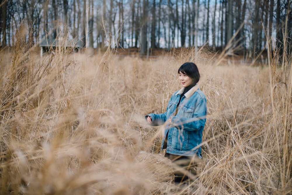 woman walking on brown grass field