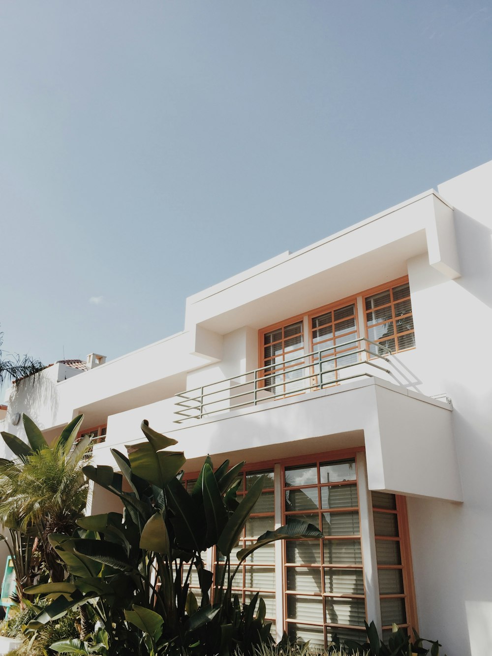 white concrete house near green leafed plants