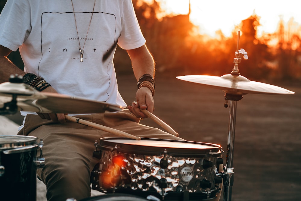 person playing drum during golden hour