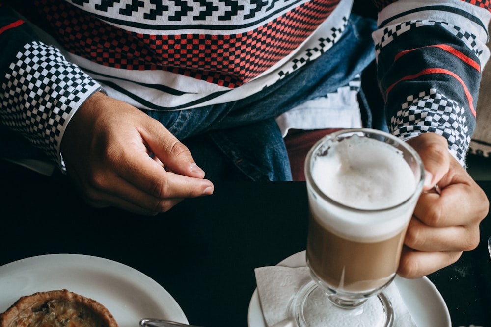 person holding a cup of chocolate milk