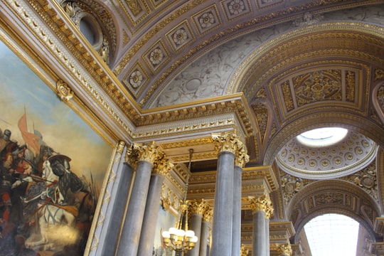 photo of building interior with painting in Jardins du Château de Versailles France