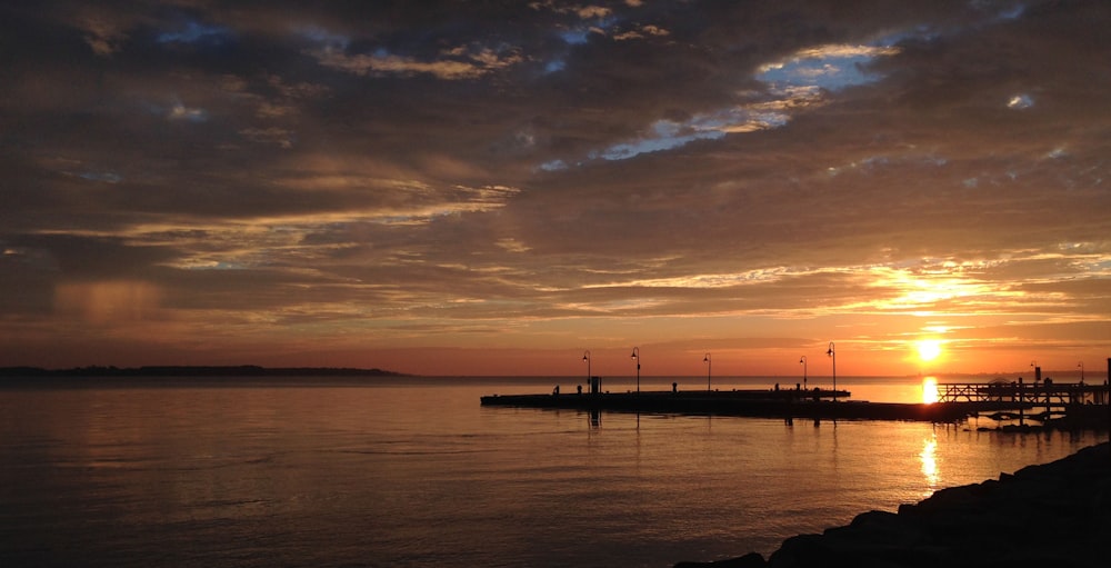 silhouette of dock during sunset