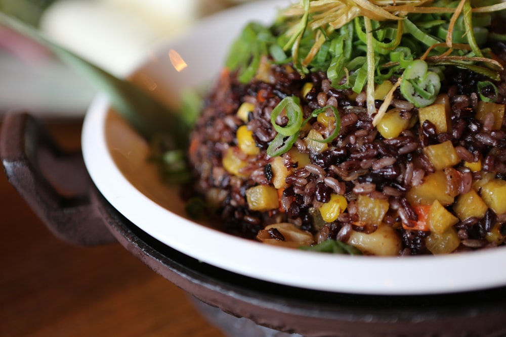 vegetable dish in white and black bowl