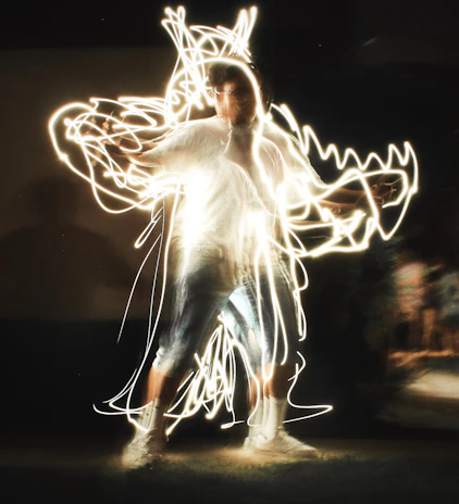 Colorful light trails swirling around Ultra Omar as he drops a fresh beat in a late-night set.