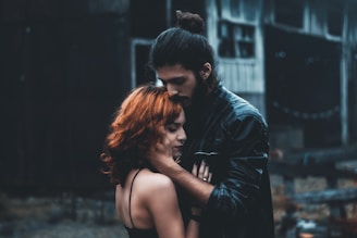 shallow focus photography of man and woman hugging