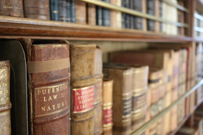 Historic property registry books open on a vintage wooden shelf.