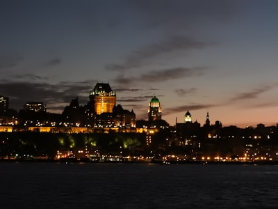 Evening cityscape of Michigan with Camier Agency office lights glowing warmly.