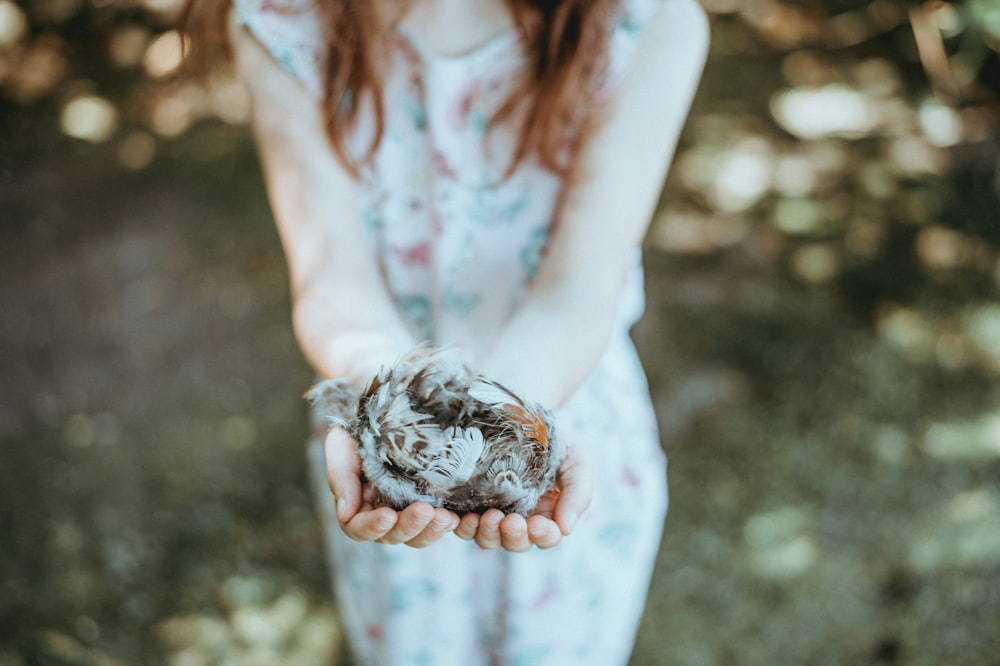 girl holding feather