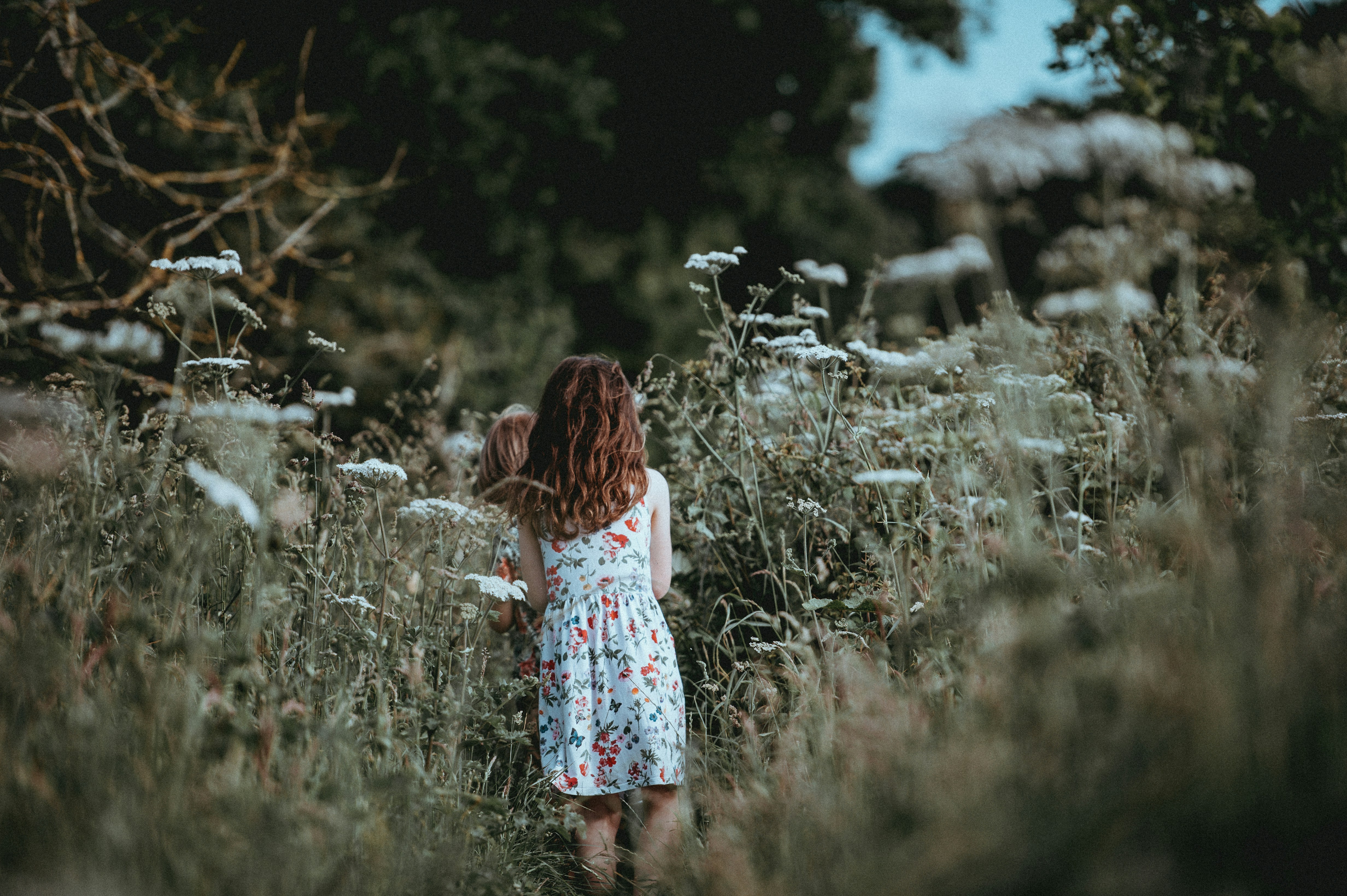 Children walking in long grass
