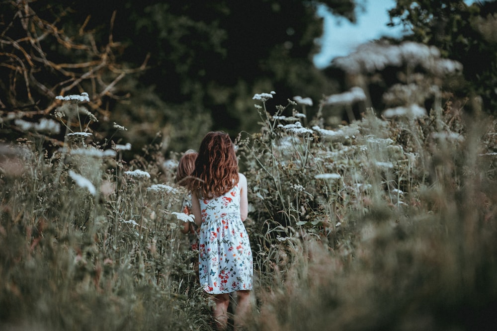 woman standing on ground covered with grass