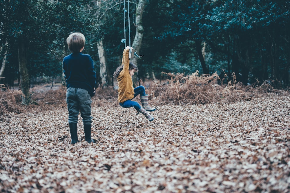 boy standing on dried leaves