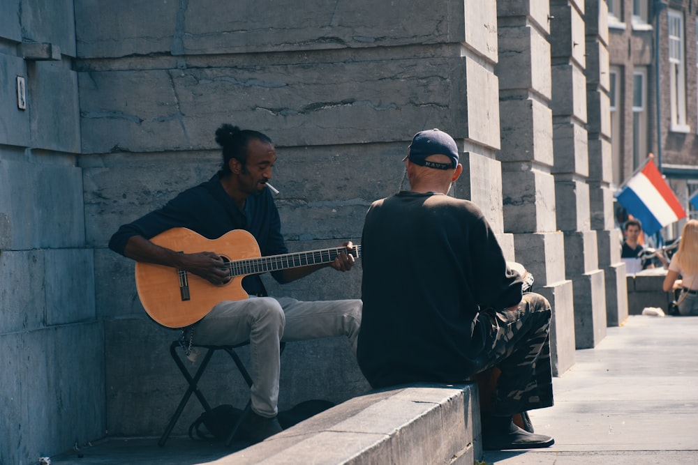 man holding acoustic guitar