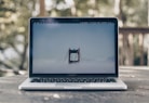 turned on MacBook Pro on gray surface