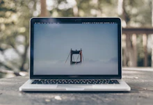 Laptop on a desk showing a travel booking page