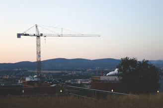 Wide shot of the crane in action with the Santa Marta coastline in the background