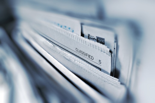 Documentaries: classified page 5 of a newspaper in selective focus photography